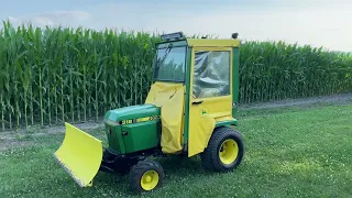 John Deere 318 with blade and snow cab