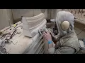 Stonemason carving portland voussoirs