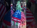 Download Lagu Woman dresses as the Statue of Liberty chained up in protest to Trump and Elon Musk.