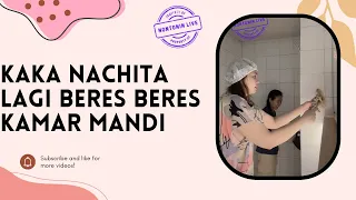 nachita is tidying up before going live to sell preloved clothes 