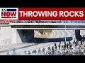 Anti-ICE protesters throw rocks at California law enforcement vehicles on freeway in Los Angeles