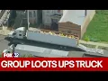 Group loots UPS truck after it strikes viaduct in Chicago