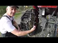 Aquiline Talon Tractor Tire Chains Installation Kubota LX2610 compact tractor outdoors