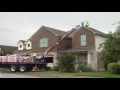 Loading Shingles on Roof Dropping Packages of Shingles