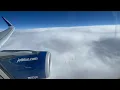 JetBlue Flight 19 skimming some clouds over the Central United States of America