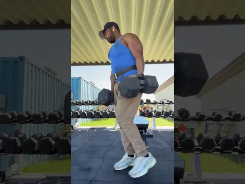 Lifting hundred pound dumbbells for reps