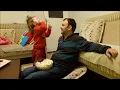Little girl feeds her father with popcorn