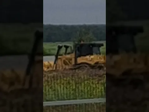 A bulldozer pushes the earth