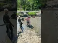 Download Lagu Man helps a disabled woman into a mud bath.