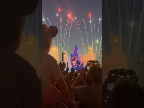 Disneyland. Alice watches the show on her dad's shoulders.
