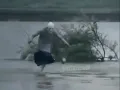 Old lady dancing in the water with bags
