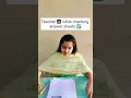 Teacher while checking answer sheets