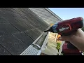 Installing Waterlock gutter protectors on the house