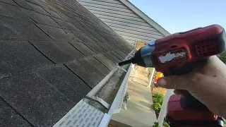 Installing Waterlock gutter protectors on the house