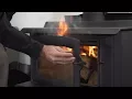 Why does smoke come into the room when I open the wood burner door