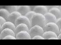 closeup spinning full-frame macro background of cotton earbud heads