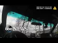 Police cam shows officers circling the parking lot where teen died in his car