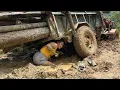 Download Lagu Agricultural vehicle transporting timber on dirt road stuck in mud