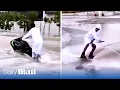 Download Lagu Thrill seeking Emiratis on jet skis swerve through Dubai's flooded roads after heavy rains sink cars