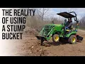 TINY TRACTOR TACKLES STUMPS WITH FRONT HOE BUCKET