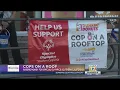 Local officers stake out roofs of Dunkin Donuts locations for fundraiser