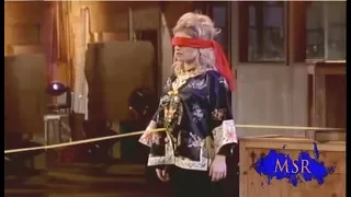 bullseye magician fires arrow through assistants stomach and hits the target 