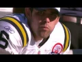 Mark Sanchez eats a hot dog on the sidelines