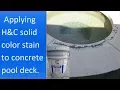 Applying H C Colortop solid color stain to a concrete pool deck