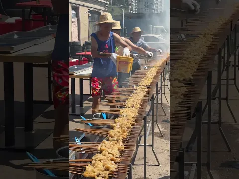 Seasoning Hundreds Of Grilled Skewers With Assembly‑Line Workers Sprinkling Different Spices