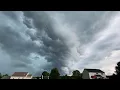 Panoramic thunderstorm capturing the calm before the storm with raw of strong winds