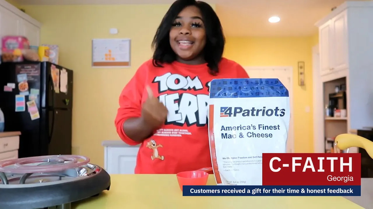 C-Faith from Georgia presents a 4Patriots emergency food kit featuring mac and cheese in her kitchen, sharing a video testimonial on its taste and convenience.