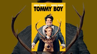 Chris Farley as Tommy Callahan holding a model car in front of David Spade as Richard Hayden in the Tommy Boy game.