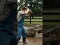 Man Confronts Crocodile with Axe
