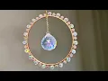 Tutorial for wire wrapping a small metal hoop frame with hanging crystal in the center