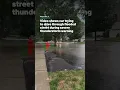 shows car trying to drive through flooded street during severe thunderstorm warning