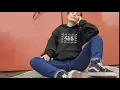 of a woman sitting down with legs open wearing a pullover hoodie a13116