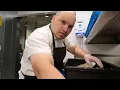 THE DISHWASHER MAN IS A COLLEGE STUDENT WASHING DISHES WITH HOPES OF DIPLOMA MINIMUM WAGE WORK