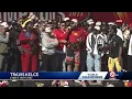 Chiefs tight end Travis Kelce speaks sings with teammates at rally