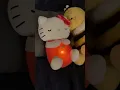 A cute pink white Hello Kitty plush toy with a light-up belly breathes