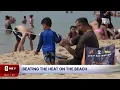 Neighbors flock to Holland State Park to beat the heat as West Michigan temperatures soar