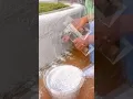 Lagu Worker carefully applying thick cement layer on concrete wall