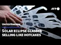 Queue for eclipse glasses outside London tube bakery as solar event nears AFP