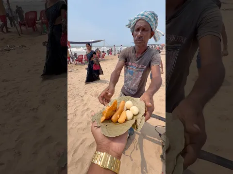 Hardworking Man Selling a Indian Sweet of Puri Sea Beach