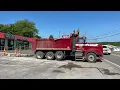 A CAT 308E2 loading a western star dump truck in Woodbury TN