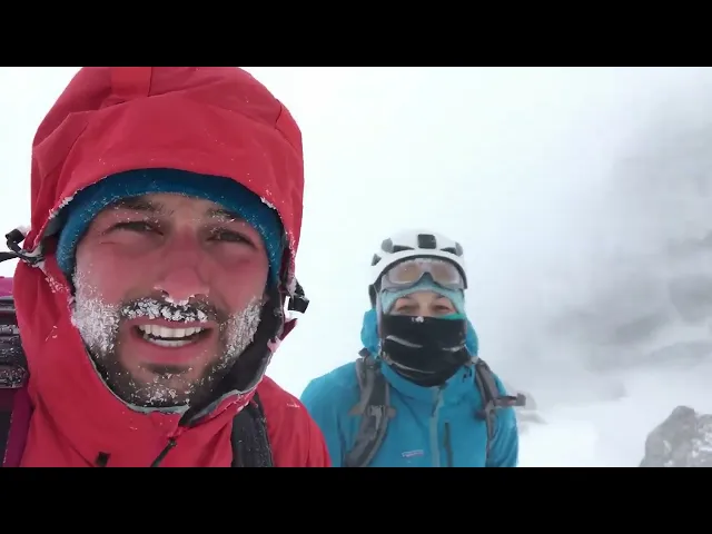 Sora 2 | Two mountain explorers in bright technical shells