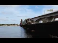 single long Hood forward Locomotive pulls a Intermodal over massive FEC Bridge