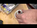 How to remove red flow restrictor from Moen shower head