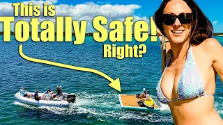 Towing a floating dock with the bikini clad ladies on the back