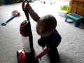 Lagu playing with his new toy vacuum cleaner