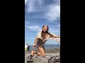 Granny doing yoga after ocean swim